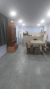 a living room with a table and a fireplace at Отдых на море in Grigoleti