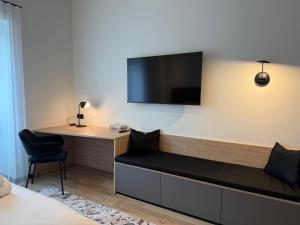 a room with a desk and a tv on the wall at Teguri Apartments in Tartu