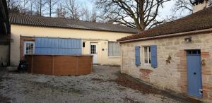 a house with a large garage next to a building at La Maison d'Onésiphore in Cazes-Mondenard