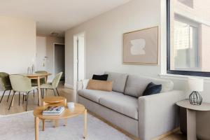 a living room with a couch and a table at Blueground Upper East Side AC wd nr parks NYC-1635 in New York