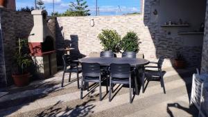 a black table and chairs on a patio at Grande Bilocale con giardino in Lizzano