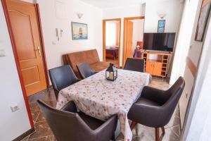 a dining room with a table and some chairs at Villa Ana in Baška