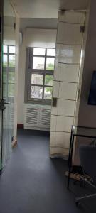 an empty room with a room with a window and a shelf at Evangelia1 Comfortable room, Exquisite View in Athens +8 photos