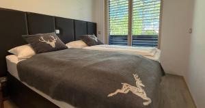 a bedroom with two beds and a window at Vila Mojca SKI IN&OUT - Apartmaji Lena in Kranjska Gora