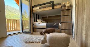 a bedroom with a bunk bed and a large window at Vila Mojca SKI IN&OUT - Apartmaji Lena in Kranjska Gora