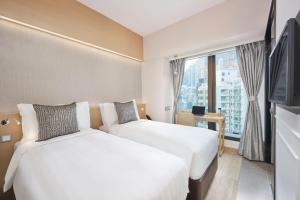 Giường trong phòng chung tại Y Hotel Hong Kong