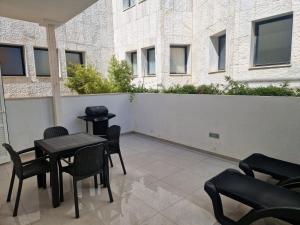 a patio with a table and chairs and a building at Playa Son Moll in Cala Ratjada