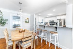 a kitchen and dining room with a wooden table and chairs at Ardmore Neighborhood Gem - pet and kid friendly in Winston-Salem