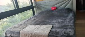 a bed in a room with a large window at Dream of Byblos in Jbeil