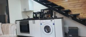 a washing machine in a living room with a staircase at Dream of Byblos in Jbeil