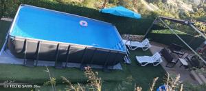 an overhead view of a swimming pool with two chairs at Dream of Byblos in Jbeil