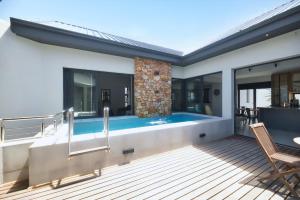 a pool on the deck of a house at Fynbos Hill Luxury Accommodation in Agulhas