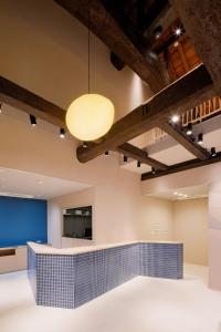 a lobby with a blue tile counter and a light fixture at The 曜 Terrace in Hirado
