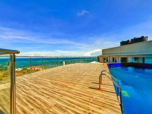 a swimming pool on top of a building with the ocean at Nyali Luxury Apartments, Antalya in Mombasa