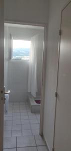 a bathroom with a shower and a window and a toilet at Beautiful studio with balcony in Gap