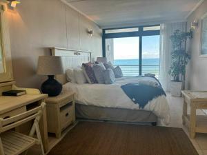 a bedroom with a bed with a view of the ocean at Elegant Family Retreat with Ocean Views in Umdloti