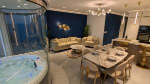 a living room with a tub and a table and chairs at Larimar - Blue Haven in Marsalforn