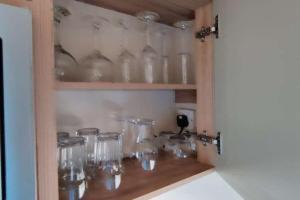 a cabinet filled with glass jars on a wooden shelf at The Chillout in Knaresborough