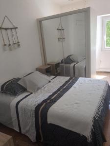 una camera da letto con un letto grande e uno specchio di Casa Di mamou a Loreto-di-Tallano