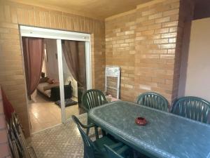 a room with a table and chairs and a living room at Bahia Park, Steps from beach! in Oropesa del Mar