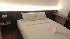 Postel nebo postele na pokoji v ubytování T Hotel SP Pekan Lama