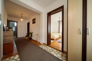 a hallway with a door leading to a living room at Akác Apartmanház in Odorheiu Secuiesc +38 photos