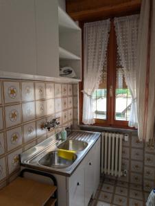a small kitchen with a sink and a window at Iseo Lake Terrace in Sale Marasino