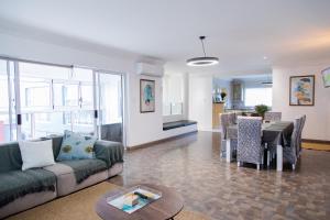 a living room with a couch and a table at Vredekloof Views in Cape Town