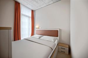 Posteľ alebo postele v izbe v ubytovaní Ariv Design Hotel Zug