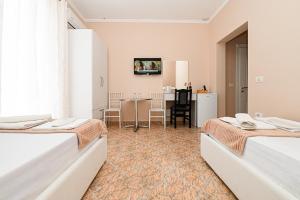 Postel nebo postele na pokoji v ubytování Hotel Fama