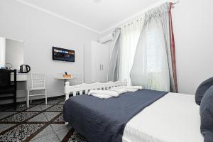 Postel nebo postele na pokoji v ubytování Hotel Fama