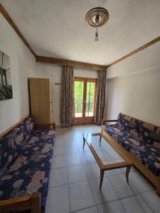 a living room with two beds and a table at Exohi apartments in Vrasná