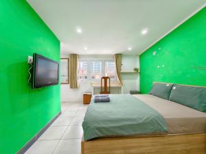 En eller flere senge i et værelse på Sen Vivian Home