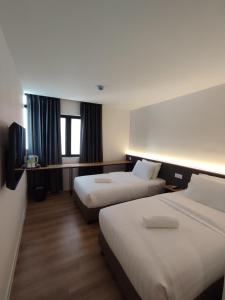 Postel nebo postele na pokoji v ubytování T Hotel SP Pekan Lama