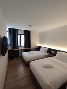 Postel nebo postele na pokoji v ubytování T Hotel SP Pekan Lama