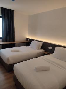 Postel nebo postele na pokoji v ubytování T Hotel SP Pekan Lama