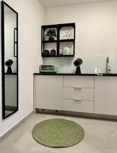 a bathroom with a sink and a mirror and a rug at Stylish Unit in Komarna - Idyllic Retreat in Komarna
