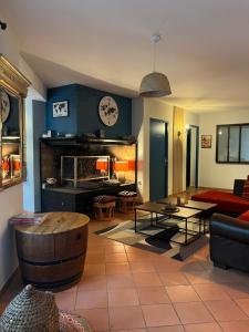 a living room with a couch and a table at Magnifique et grand loft classé 4 étoiles in Lavelanet