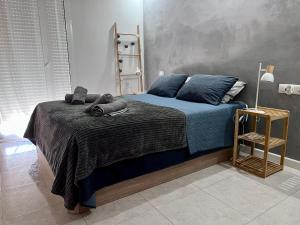 a bedroom with a bed with blue sheets and pillows at Toto&Koko apartment in Denia