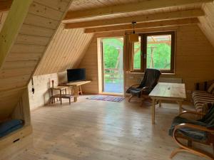 a room with a desk and a computer in a cabin at Pszczela Oaza in Bulowice