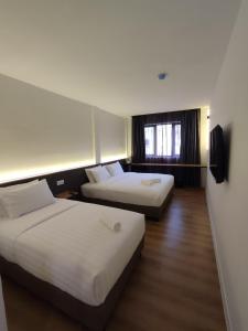 Postel nebo postele na pokoji v ubytování T Hotel SP Pekan Lama