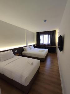 Postel nebo postele na pokoji v ubytování T Hotel SP Pekan Lama + 15 fotografií