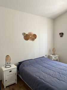 a bedroom with a blue bed and two night stands at La casina sulla valle in Dozza