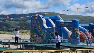 two people standing on a play structure at a playground at Talarfor Barmouth in Barmouth