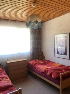 a bedroom with a bed and a teddy bear at Cosy apartment next a skislope in Amden