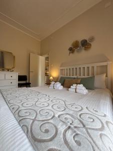 a bedroom with a large bed with a white bedspread at LA TORRE SARACENA - APARTMENTS with services & Free Parking in Palmi