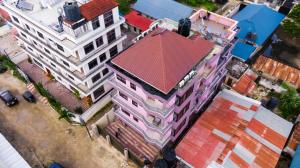 an overhead view of a pink building with a red roof at Gemson Home in Dar es Salaam
