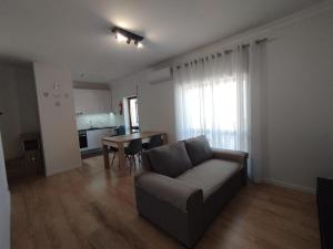 a living room with a couch and a table at Casa da TITA in Vila Praia de Âncora