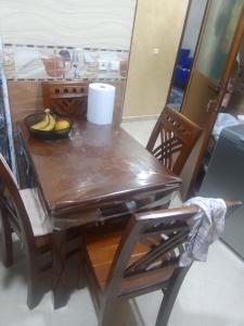 a wooden table with a bowl of bananas on it at Appartement aissa in Oulad Akkou +8 photos