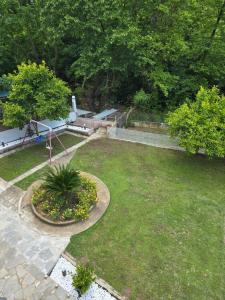 an aerial view of a garden with a playground at Exohi apartments in Nea Vrasna
